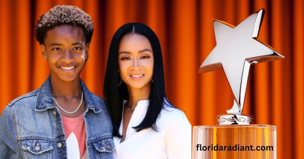 Son and Mom stand next to a star award, symbolizing recognition and accomplishment in their respective fields.