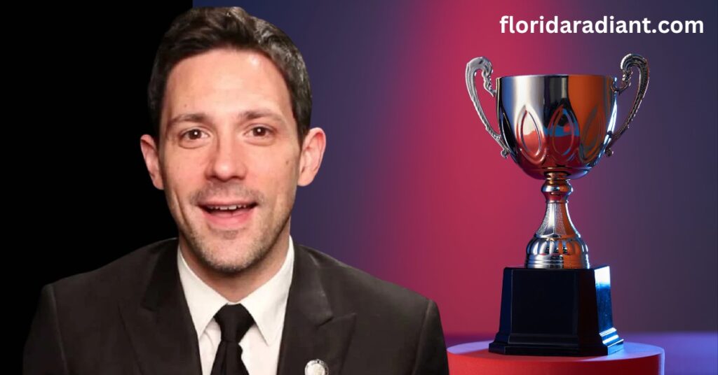 A man wearing a suit and tie stands with a trophy in hand, representing his victory and excellence in a competitive environment.