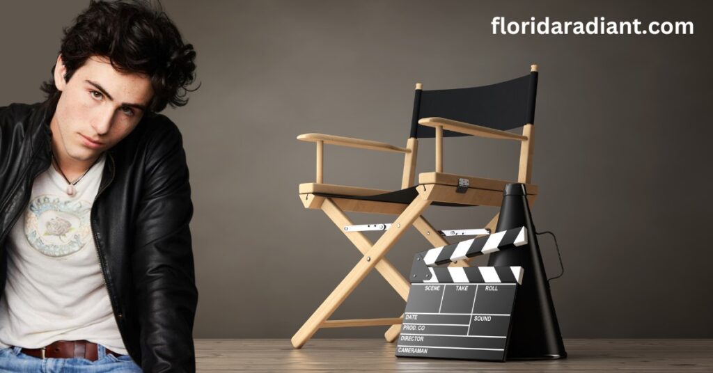 A man in a relaxed pose on a chair next to a director's chair, indicating a moment of discussion or planning.