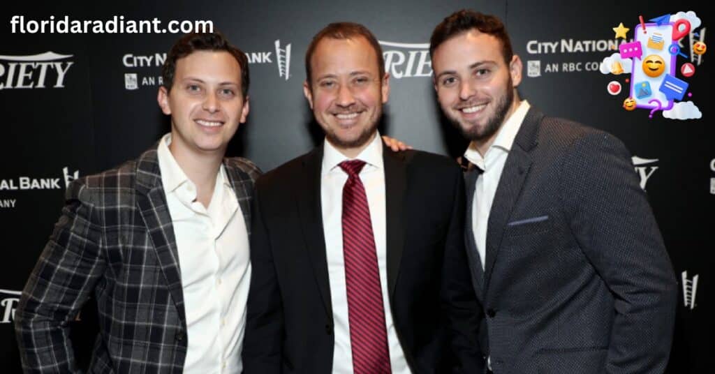 Three well-dressed men in suits posing together for a photograph at a social gathering.