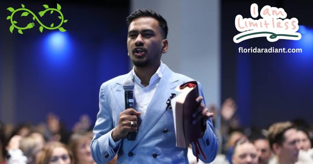 A suited man presents a book to an engaged audience, showcasing his knowledge and leadership.