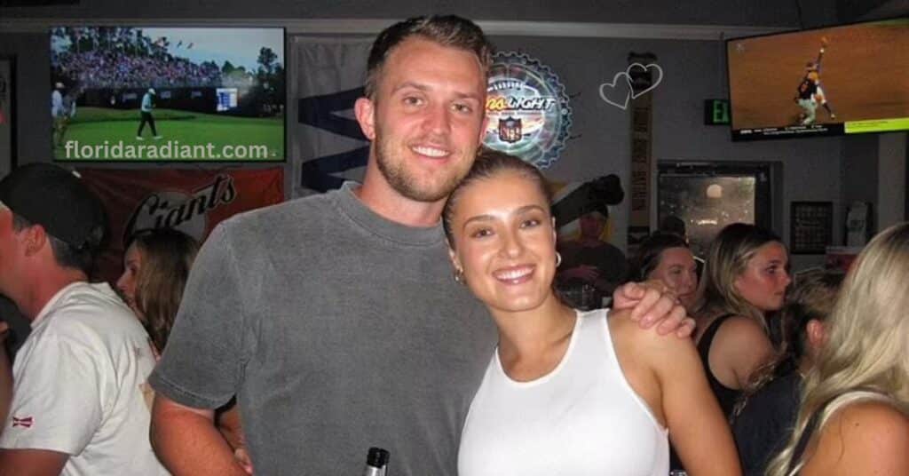 A man and woman happily posing for a photo at a bar, capturing a moment of joy amidst the lively surroundings.