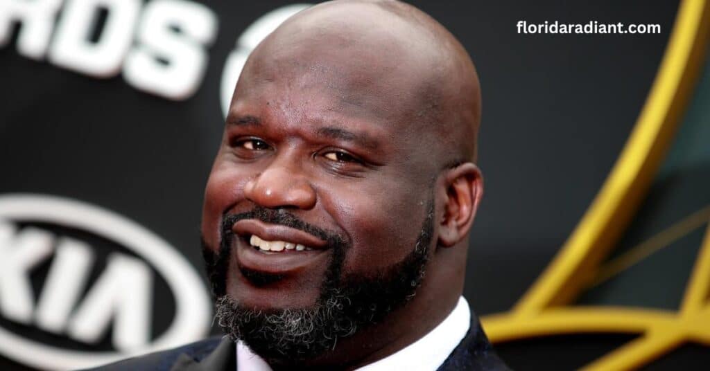 A bald man in a suit and tie smiles confidently, exuding professionalism and warmth.