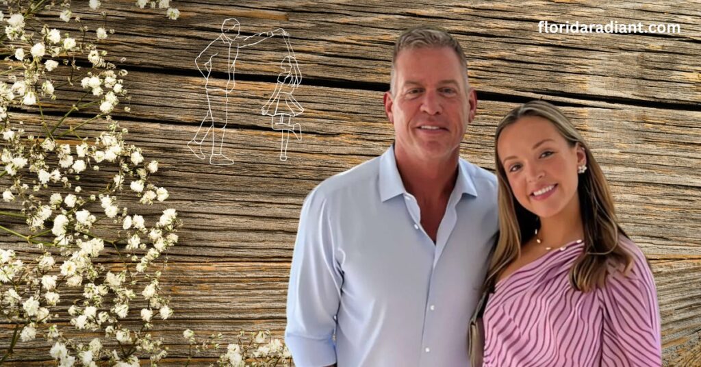 A man and woman stand side by side, posing in front of a rustic wooden wall, showcasing a warm and inviting atmosphere.